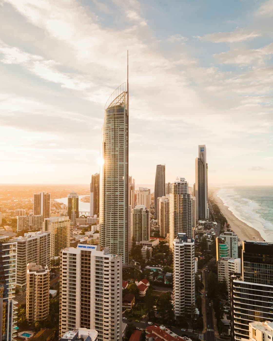 High-rise towers on a live construction skyline at golden hour
