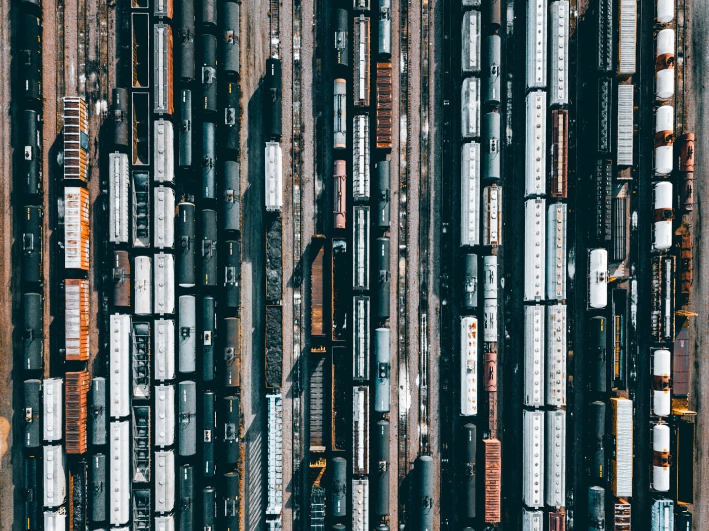 Rows of freight wagons in a rail yard from directly above